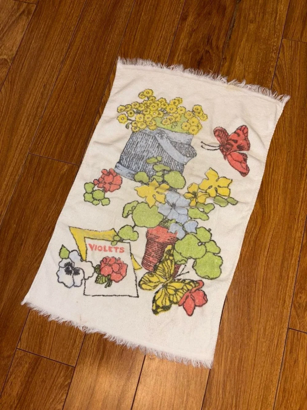 Vintage 1970s hand towel with a floral design and butterflies